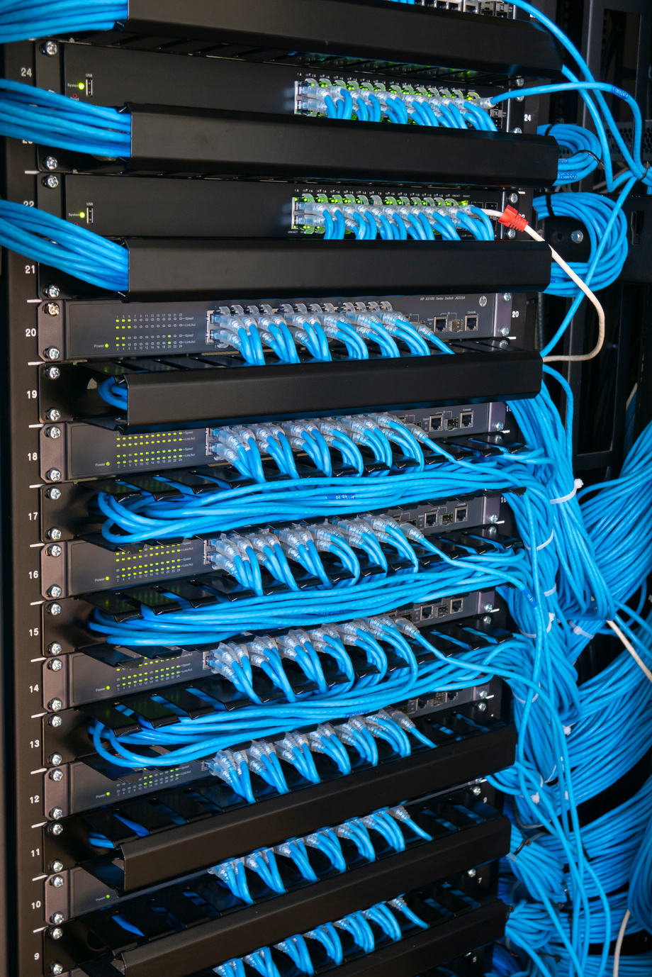 Network switch and ethernet cables in rack cabinet